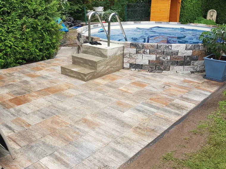 Gepflasterter Poolumgang mit heller Plattenfläche